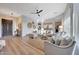 Bright and airy living room with neutral tones, wood floors, and stylish furnishings throughout the open-concept space at 18143 W Buckhorn Dr, Goodyear, AZ 85338
