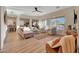 Spacious living room with large windows, neutral decor, and seamlessly connected to the dining and kitchen areas at 18143 W Buckhorn Dr, Goodyear, AZ 85338