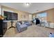 Spacious office with a desk, a large TV, and a comfortable sofa at 18143 W Buckhorn Dr, Goodyear, AZ 85338
