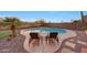 Inviting backyard pool with desert landscape, turf, and lounge chairs, perfect for relaxation and entertaining at 18143 W Buckhorn Dr, Goodyear, AZ 85338