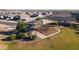 An aerial view of a neighborhood park showcasing a playground and picnic areas at 18224 N Toledo Ave, Maricopa, AZ 85138