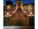 A home with a stone facade, a circular tower, and manicured landscaping offers a grand and inviting entrance at 18346 W Rancho Ct, Litchfield Park, AZ 85340