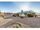 Backyard featuring desert landscaping, patio and lawn, surrounded by neighboring houses at 19601 N 99Th Dr, Sun City, AZ 85373