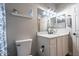 Bright bathroom featuring a modern vanity, decorative mirror, and new toilet at 20100 N 78Th Pl # 2098, Scottsdale, AZ 85255