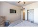 A neat bedroom featuring a television and a sliding-door closet with ample storage space at 20100 N 78Th Pl # 2098, Scottsdale, AZ 85255