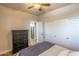 Bedroom features a ceiling fan, hardwood floors, and a view into the kitchen at 20100 N 78Th Pl # 2098, Scottsdale, AZ 85255