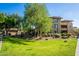 Apartment building exterior surrounded by well-manicured lawn and trees at 20100 N 78Th Pl # 2098, Scottsdale, AZ 85255