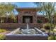 Elegant community center featuring a stone facade with a tranquil water feature and lush landscaping at 20100 N 78Th Pl # 2098, Scottsdale, AZ 85255