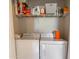 Laundry room featuring a washer, a dryer, and wire shelving full of cleaning supplies at 20100 N 78Th Pl # 2098, Scottsdale, AZ 85255