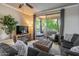 Cozy living room featuring a large sectional sofa, plush ottoman, and a patio view at 20100 N 78Th Pl # 2098, Scottsdale, AZ 85255