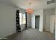 Bedroom with neutral carpet, white walls, closet and window with patterned curtains at 2079 N Marketside Ave, Buckeye, AZ 85396