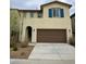 Two-story home featuring a brown garage door, blue shutters, and desert landscaping at 2079 N Marketside Ave, Buckeye, AZ 85396