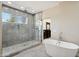 Modern bathroom featuring dual sinks, a soaking tub, separate walk-in shower, and elegant fixtures at 24201 N 87Th St, Scottsdale, AZ 85255