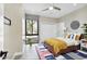 Cozy bedroom featuring a stylish ceiling fan, large window, and comfortable bed at 24201 N 87Th St, Scottsdale, AZ 85255