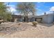 Contemporary home with a unique architectural design, desert landscaping, and gravel driveway at 24201 N 87Th St, Scottsdale, AZ 85255