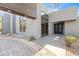 Modern home entrance with gray concrete exterior, black framed windows and double door entryway at 24201 N 87Th St, Scottsdale, AZ 85255