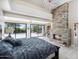 Spacious main bedroom featuring fireplace, large windows, access to the backyard, chandelier, and lots of natural light at 24201 N 87Th St, Scottsdale, AZ 85255