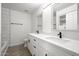 Elegant bathroom with a double sink vanity, sleek fixtures, and a marble tile shower at 25073 W Dove Trl, Buckeye, AZ 85326