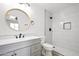 Stylish bathroom featuring a modern vanity, unique mirror, and tiled walk-in shower at 25073 W Dove Trl, Buckeye, AZ 85326