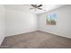 Neutral bedroom with carpet flooring, ceiling fan, and natural lighting at 25073 W Dove Trl, Buckeye, AZ 85326
