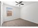 Neutral bedroom with carpet flooring, ceiling fan, and natural lighting at 25073 W Dove Trl, Buckeye, AZ 85326