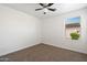 This bedroom features plush carpeting, neutral paint and a ceiling fan at 25073 W Dove Trl, Buckeye, AZ 85326