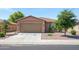 Charming single-story home featuring a well-maintained lawn and a two-car garage at 25073 W Dove Trl, Buckeye, AZ 85326