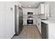 Modern kitchen featuring white cabinets, stainless steel appliances, and tile floors at 25073 W Dove Trl, Buckeye, AZ 85326
