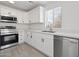 Updated kitchen features stainless steel appliances, quartz countertops and tile floors at 25073 W Dove Trl, Buckeye, AZ 85326