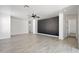 Open-concept living space featuring wood-look tile and a sleek, modern design at 25073 W Dove Trl, Buckeye, AZ 85326