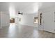 Bright living room with tile floors, leading to the backyard through sliding glass doors at 25073 W Dove Trl, Buckeye, AZ 85326