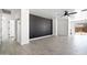 Spacious living area showcasing a striking accent wall and tile flooring throughout at 25073 W Dove Trl, Buckeye, AZ 85326