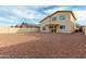 Backyard featuring rock landscaping, a covered patio, and a view of the home's exterior at 25724 W St James Ave, Buckeye, AZ 85326