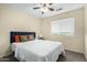 Bedroom with ceiling fan and large window for natural light at 25724 W St James Ave, Buckeye, AZ 85326
