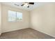 Bedroom with a large window and a ceiling fan at 25724 W St James Ave, Buckeye, AZ 85326
