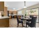 Dining area showcases a modern table and chairs, with backyard views at 25724 W St James Ave, Buckeye, AZ 85326