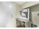 Hallway featuring a desk area with modern framed art and a white door at 25724 W St James Ave, Buckeye, AZ 85326