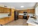 Well-lit kitchen with wood cabinets, stainless steel appliances, and light countertops at 25724 W St James Ave, Buckeye, AZ 85326