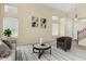 Bright living room featuring high ceilings, large windows, and neutral decor at 25724 W St James Ave, Buckeye, AZ 85326