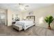 Cozy primary bedroom features a ceiling fan, soft carpet and a large window at 25724 W St James Ave, Buckeye, AZ 85326