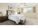 Comfortable primary bedroom offers soft carpet, ceiling fan and plenty of natural light at 25724 W St James Ave, Buckeye, AZ 85326