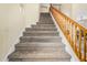 Carpeted staircase with wooden railing leads to the upper level at 25724 W St James Ave, Buckeye, AZ 85326