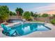 Backyard pool with a waterfall feature, hot tub, and lounge seating at 2728 W Adventure Dr, Anthem, AZ 85086