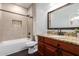 Bathroom featuring a shower and bath with a granite countertop and a decorative mirror at 290 N Nash Way, Chandler, AZ 85225