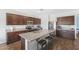 Modern kitchen featuring an island with bar seating, stainless steel appliances, and sleek dark wood cabinets at 3027 N Spring Ln, Casa Grande, AZ 85122