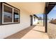 Comfortable covered back patio showcasing white siding and black trim around the windows at 3345 E Edgewood Ave, Mesa, AZ 85204