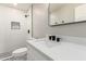 Bright bathroom featuring modern white vanity, black fixtures, and shower with tiled niche at 3345 E Edgewood Ave, Mesa, AZ 85204