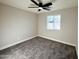 This cozy bedroom features a ceiling fan, a window providing natural light, and soft gray carpet at 3345 E Edgewood Ave, Mesa, AZ 85204