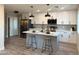 Beautifully updated kitchen with stainless steel appliances, an island with barstool seating, and stylish backsplash at 3345 E Edgewood Ave, Mesa, AZ 85204