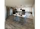 Beautifully updated kitchen with stainless steel appliances, an island with barstool seating, and stylish backsplash at 3345 E Edgewood Ave, Mesa, AZ 85204
